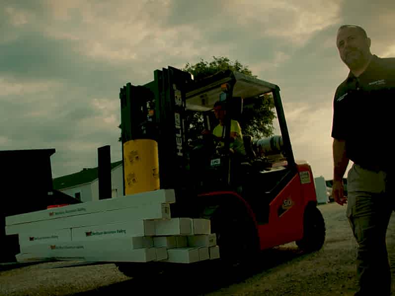 About Us Feature 1-2 Forklift and project manager walking on project site