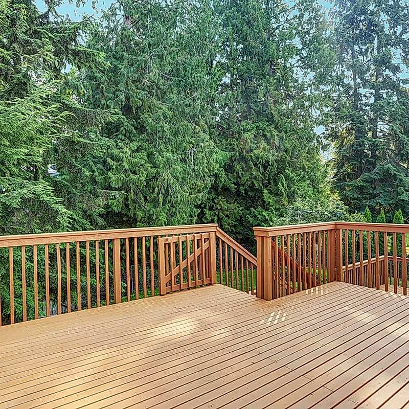 Empty walkout deck with redwood railings Large wood deck with gate