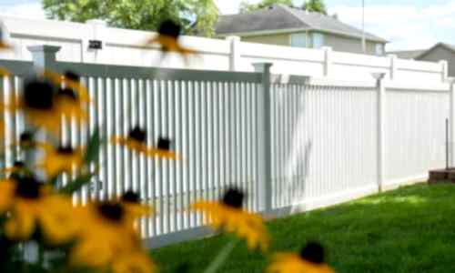 Fence-Deck-Depot-019-vinyl-fence-installati White fences with yellow flowers in foreground