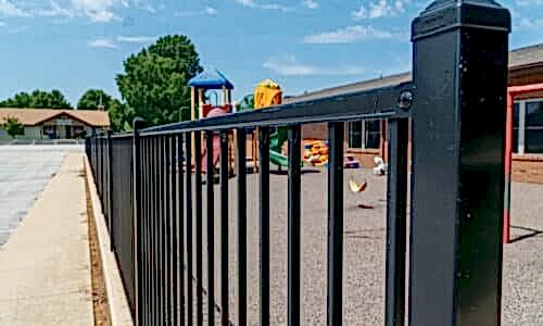Fence-Deck-Depot-580aluminum-fence-ymca-500 Close image of an aluminum fence around playground
